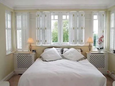 Shaped shutters on a curved bay window